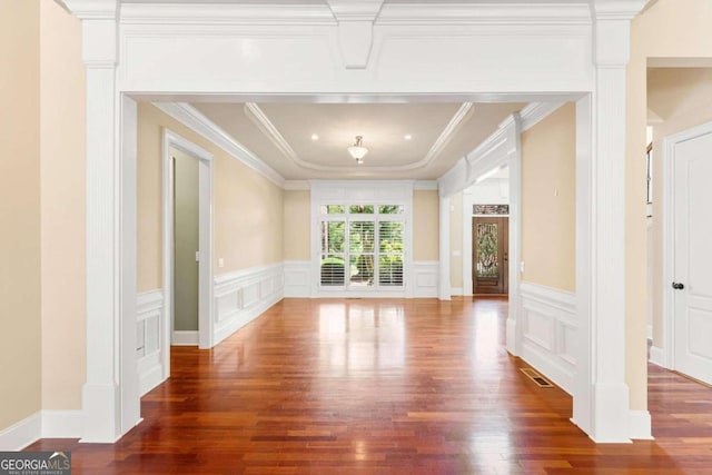 interior space featuring ornamental molding and dark hardwood / wood-style floors