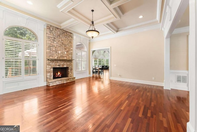 unfurnished living room with hardwood / wood-style flooring, ornamental molding, coffered ceiling, and a healthy amount of sunlight