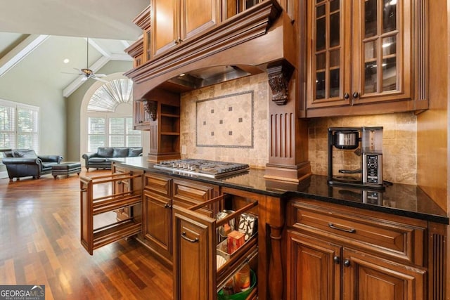 kitchen featuring premium range hood, dark wood-type flooring, lofted ceiling, ceiling fan, and stainless steel gas stovetop