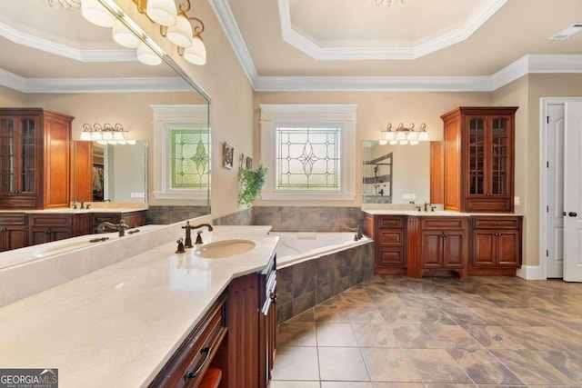 bathroom featuring a relaxing tiled tub, ornamental molding, vanity, and tile patterned floors