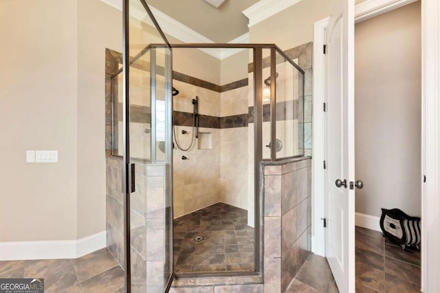 bathroom featuring a shower with door and ornamental molding