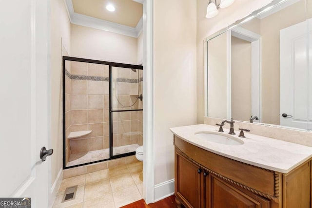 bathroom featuring toilet, an enclosed shower, crown molding, vanity, and tile patterned flooring