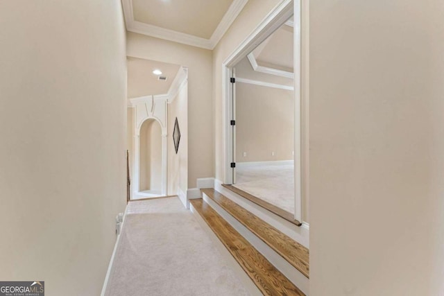 hallway with light carpet and crown molding