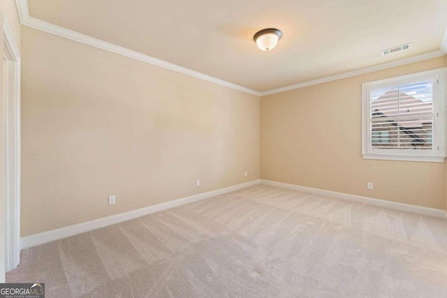 carpeted spare room with crown molding