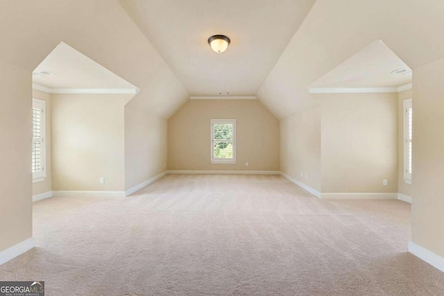 bonus room featuring vaulted ceiling and light carpet