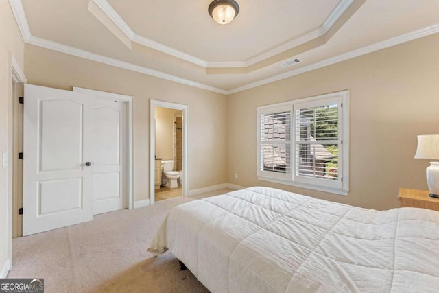 bedroom with crown molding, ensuite bathroom, a raised ceiling, and light carpet