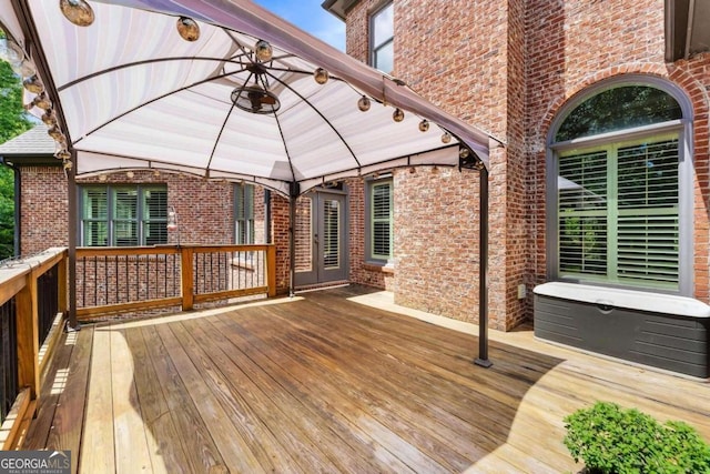 wooden terrace featuring a gazebo