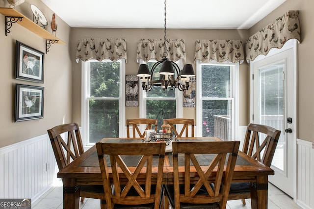 dining room featuring an inviting chandelier and light tile patterned flooring