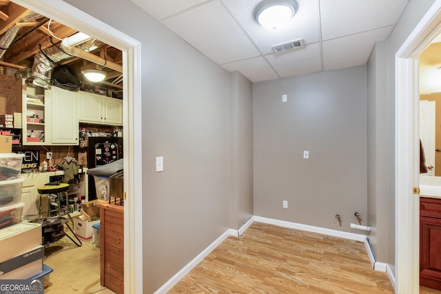 laundry room with light hardwood / wood-style floors