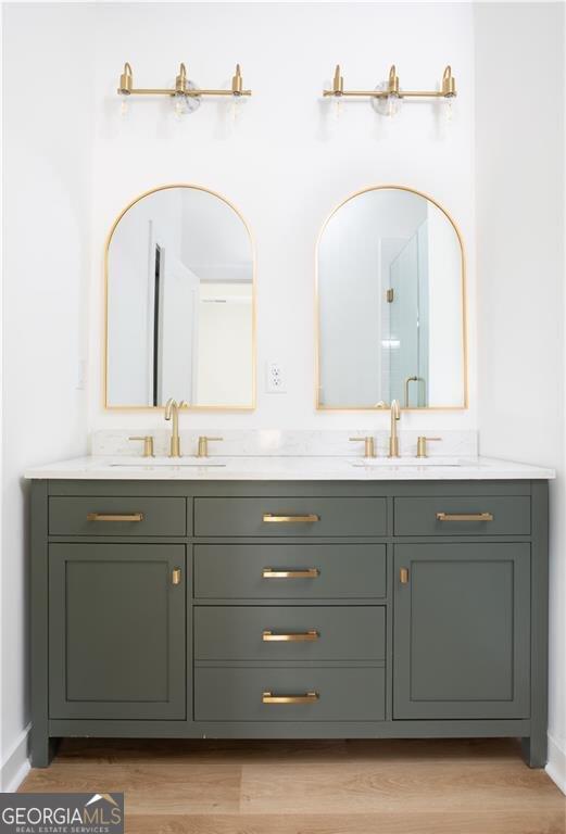 bathroom with wood-type flooring and double sink vanity