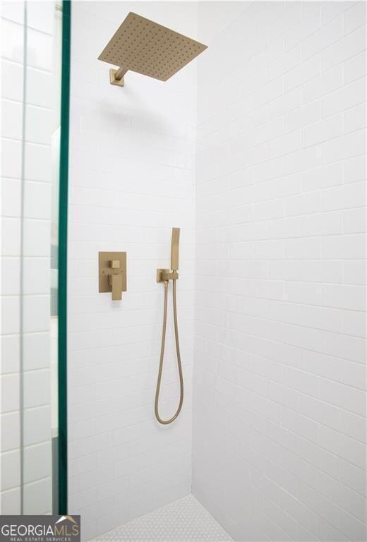 bathroom with tiled shower