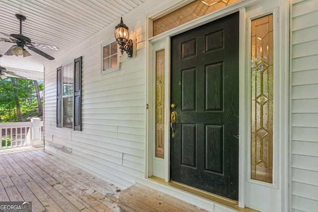 doorway to property featuring a porch and ceiling fan