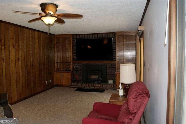 living room featuring brick wall, a textured ceiling, a brick fireplace, wood walls, and ceiling fan