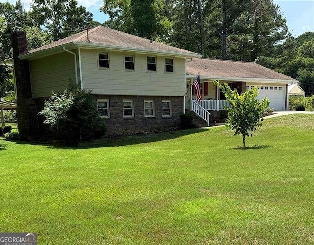 tri-level home with a garage and a front lawn