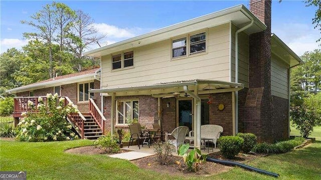 rear view of house featuring a patio and a lawn