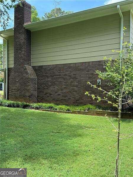 view of property exterior with a lawn