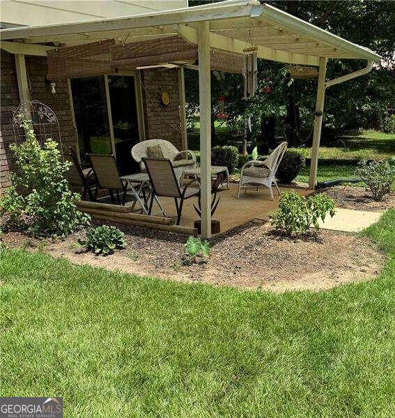 exterior space featuring ceiling fan and a patio area