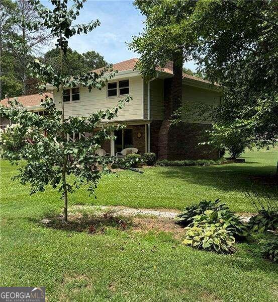 rear view of house with a yard