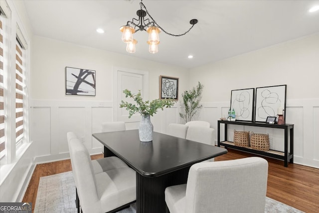 dining room with ornamental molding, a chandelier, and dark hardwood / wood-style flooring