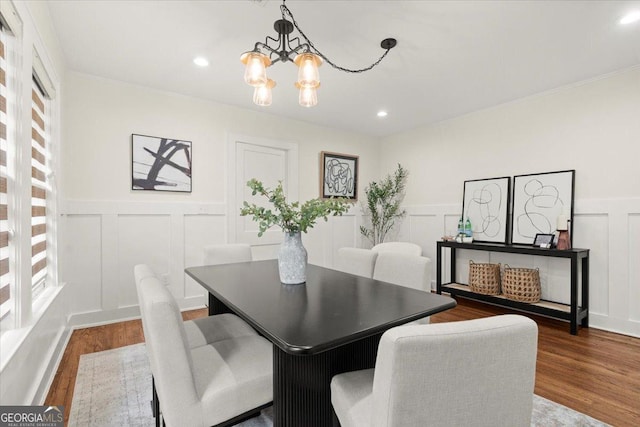 dining area with a notable chandelier and hardwood / wood-style flooring