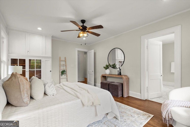 bedroom featuring crown molding, wood-type flooring, and ceiling fan