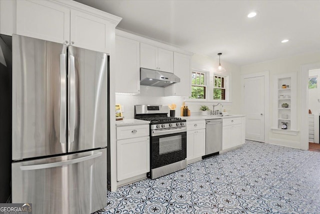 kitchen with stainless steel appliances, sink, pendant lighting, and white cabinets