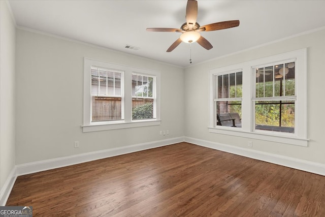 spare room with ornamental molding, dark hardwood / wood-style floors, and ceiling fan