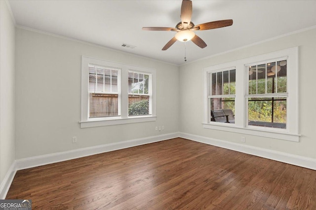 spare room featuring crown molding, ceiling fan, and dark hardwood / wood-style floors