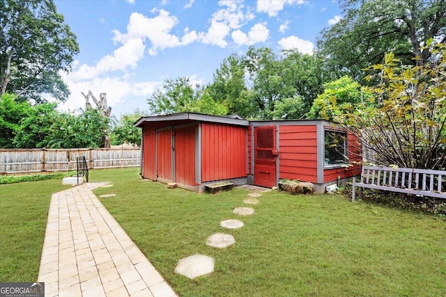 view of outbuilding featuring a lawn