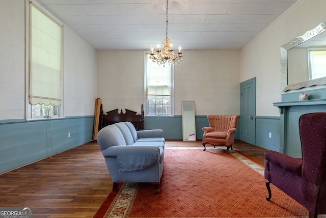99 W Main St, Gibson, GA 30810 - living area with wood finished floors, healthy amount of natural light, and a chandelier