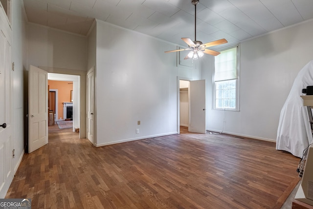 99 W Main St, Gibson, GA 30810 - unfurnished bedroom featuring crown molding, wood finished floors, a high ceiling, and a ceiling fan