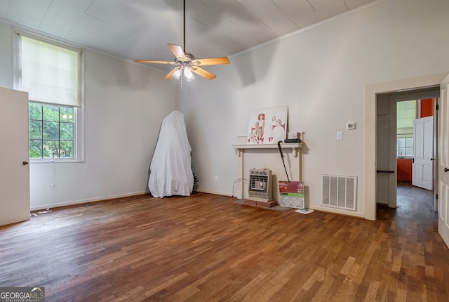 99 W Main St, Gibson, GA 30810 - spare room featuring ornamental molding, wood finished floors, a ceiling fan, and heating unit