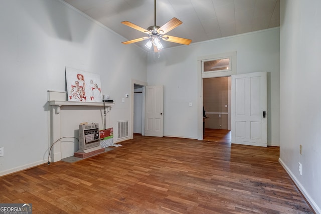 99 W Main St, Gibson, GA 30810 - unfurnished bedroom featuring crown molding, wood finished floors, heating unit, and ceiling fan