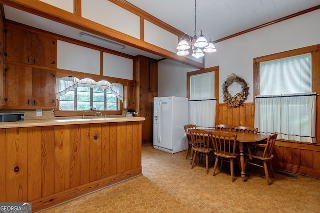 99 W Main St, Gibson, GA 30810 - dining area featuring a chandelier, crown molding, wooden walls, wainscoting, and light floors