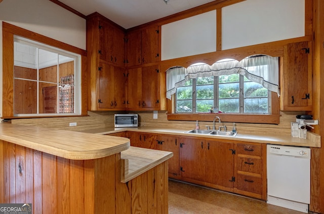 99 W Main St, Gibson, GA 30810 - kitchen featuring dishwasher, stainless steel microwave, light countertops, a peninsula, and brown cabinets