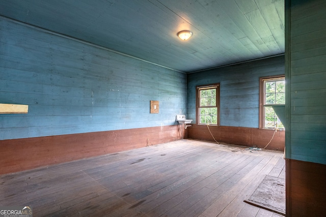 99 W Main St, Gibson, GA 30810 - spare room with hardwood / wood-style flooring and wooden walls