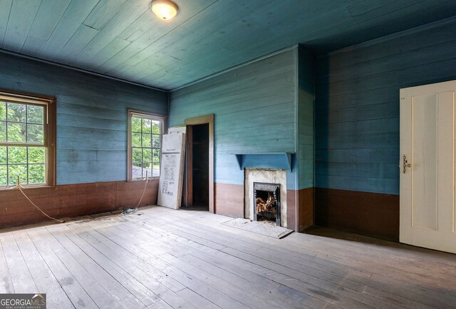 99 W Main St, Gibson, GA 30810 - unfurnished living room featuring a premium fireplace, wood walls, hardwood / wood-style floors, and wood ceiling