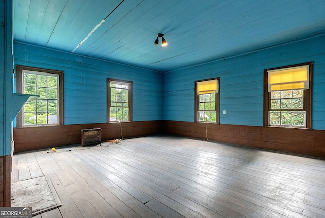 99 W Main St, Gibson, GA 30810 - empty room featuring wood-type flooring, wood walls, and wood ceiling