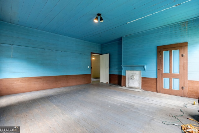 99 W Main St, Gibson, GA 30810 - empty room with wood walls, hardwood / wood-style flooring, and wood ceiling