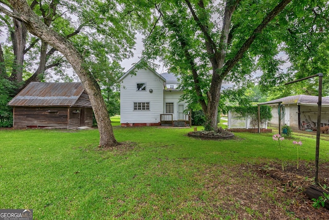 99 W Main St, Gibson, GA 30810 - view of grassy yard featuring an outbuilding