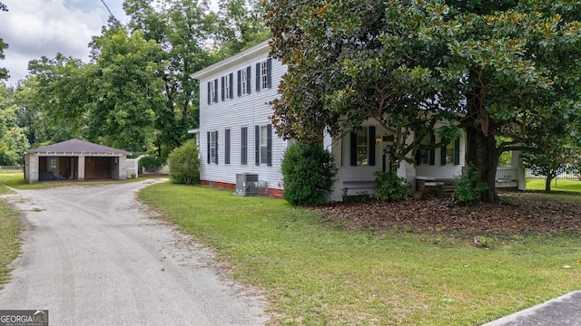 99 W Main St, Gibson, GA 30810 - view of front of house featuring a front lawn, dirt driveway, and a detached garage