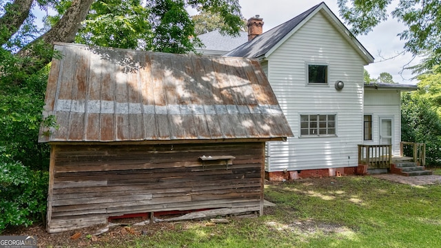 99 W Main St, Gibson, GA 30810 - back of house with a yard, a chimney, and a metal roof