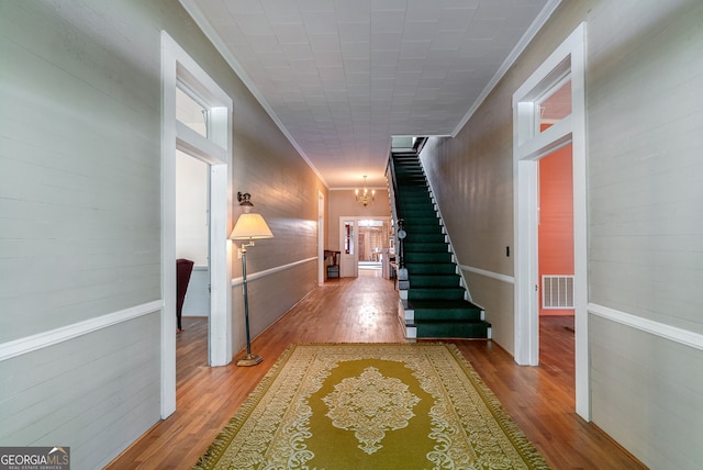 99 W Main St, Gibson, GA 30810 - hallway with crown molding, a chandelier, wood finished floors, and stairs