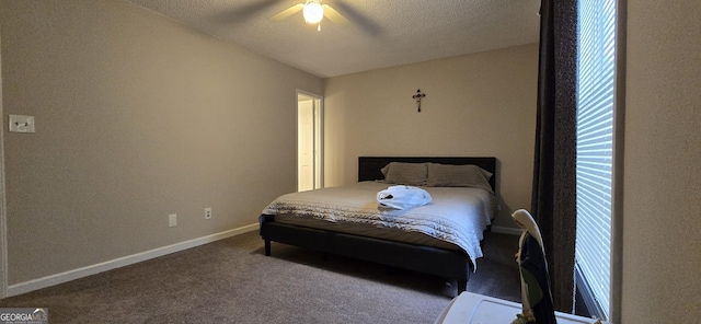 bedroom with ceiling fan, carpet flooring, and a textured ceiling