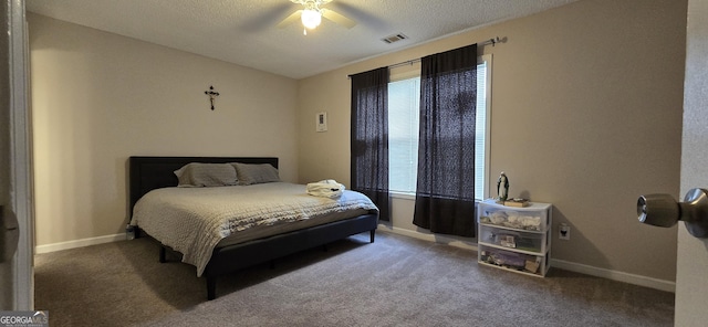 carpeted bedroom with ceiling fan and a textured ceiling