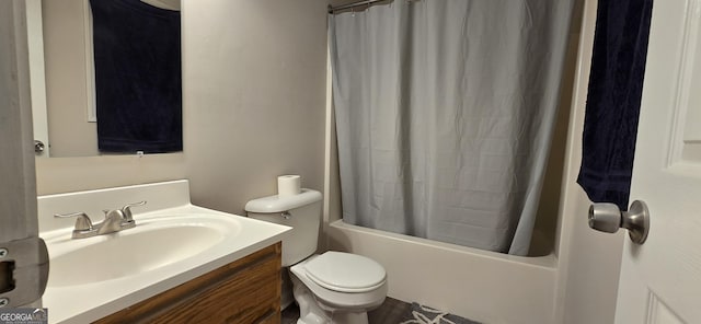 full bathroom featuring vanity, shower / bath combo with shower curtain, and toilet