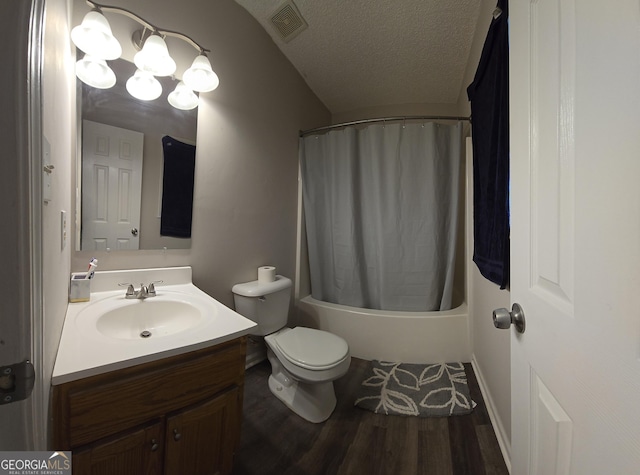 full bathroom featuring shower / tub combo with curtain, wood-type flooring, vanity, toilet, and a textured ceiling