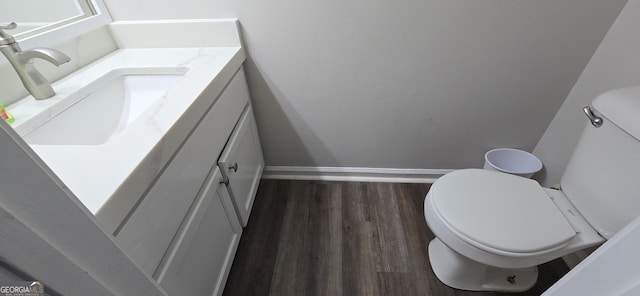 bathroom with vanity, wood-type flooring, and toilet