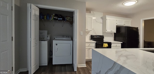 kitchen featuring black appliances, a textured ceiling, washer and dryer, dark hardwood / wood-style flooring, and white cabinets