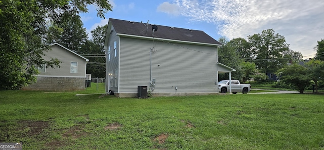 view of property exterior with central AC and a lawn